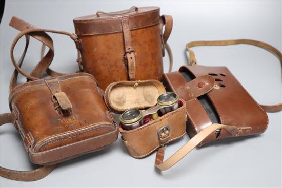 A pair of cased opera glasses, two pairs of cased binoculars and a Zeiss Ikon Nettar cased camera